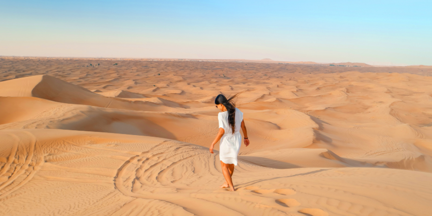 Photo of an expat walking in the dessert in Dubai